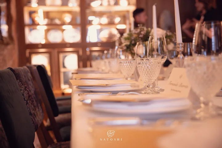 Place settings and a long dining table prepared for the Satoshi Dinner in Paris