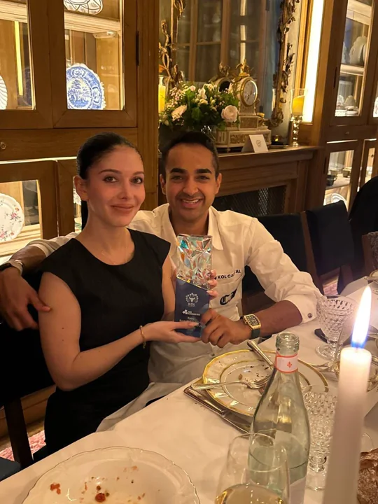 Two attendees at the Satoshi Dinner in Paris holding the award
