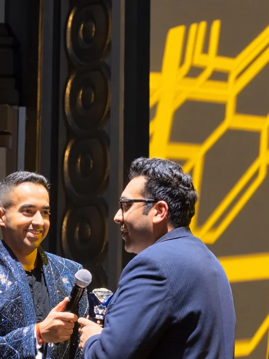 A Travls representative meeting a presenter at the Singapore awards ceremony
