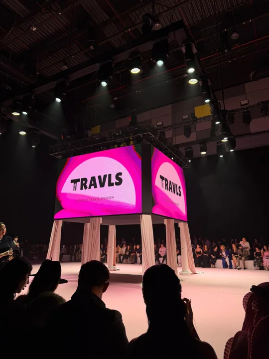 A stage display with Travls branding and the DJFW audience